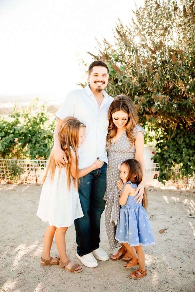 Family of 4 embracing