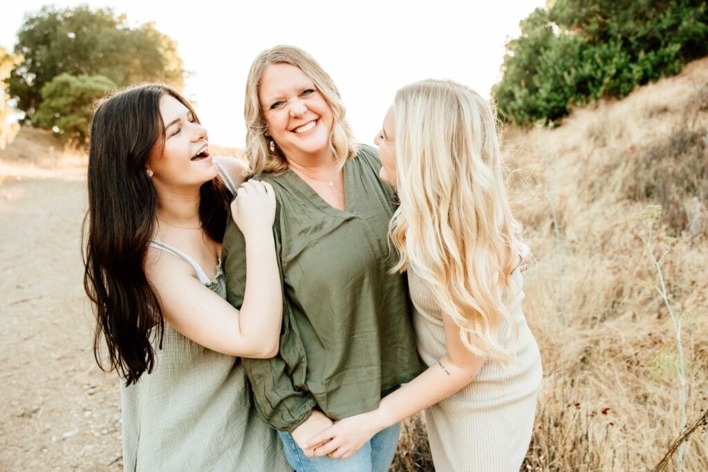 Mom poses with her 2 adult daughter