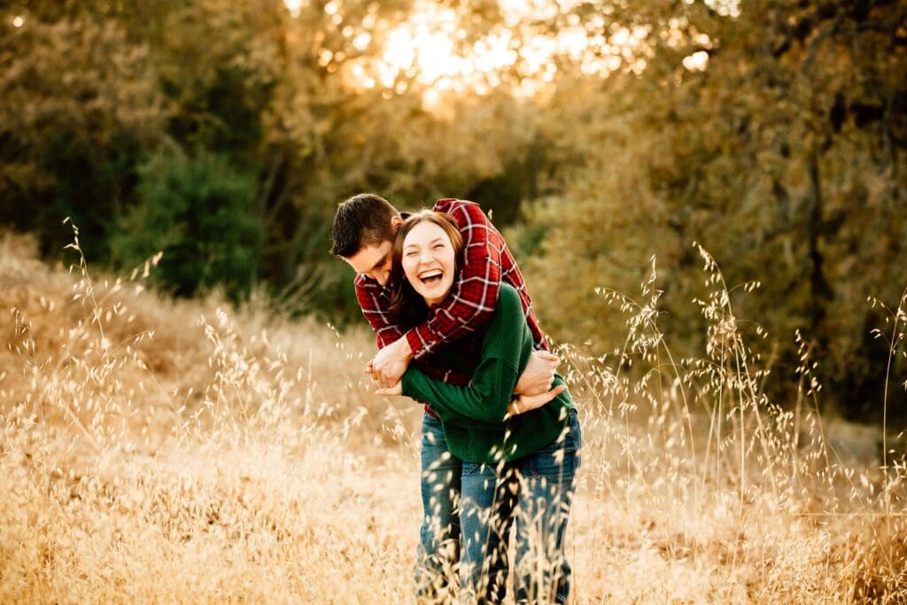 dad hugs teen daughter for a blog post about the importance of family photos with older kids