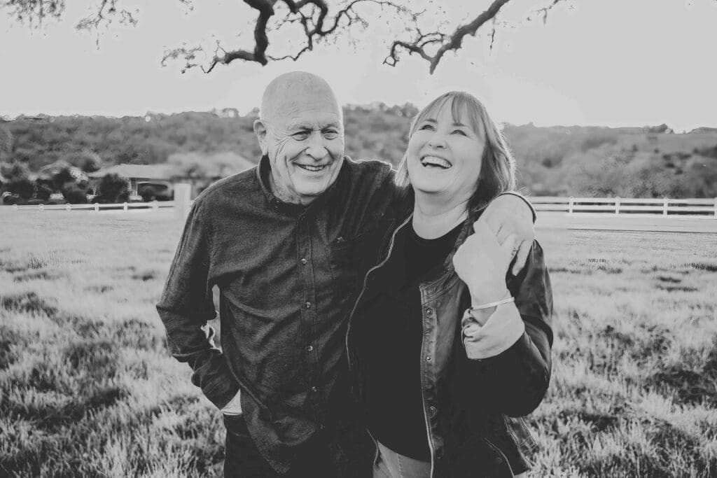 father and adult daughter laughing