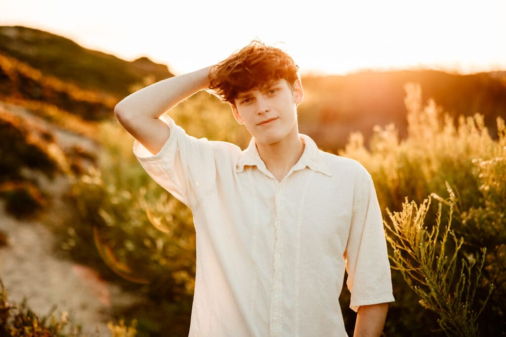 Backlit portrait of a senior boy in Pismo Beach.