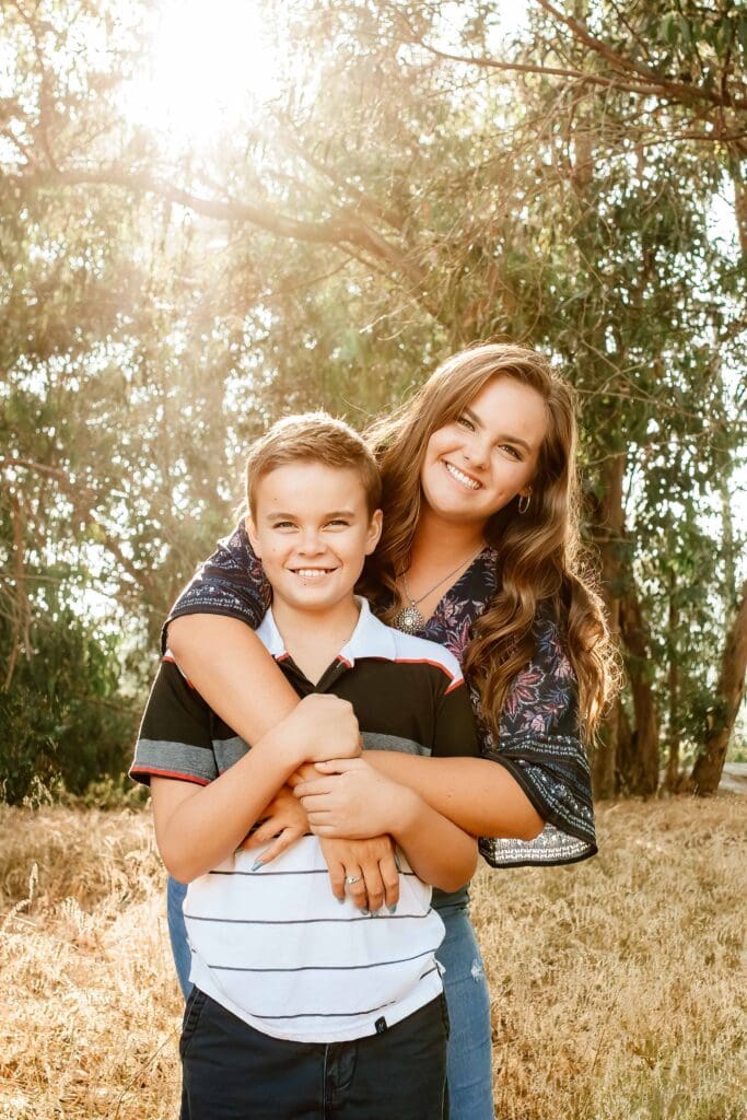 Backlit photo of a brother and sister at Monarch Butterfly Grove