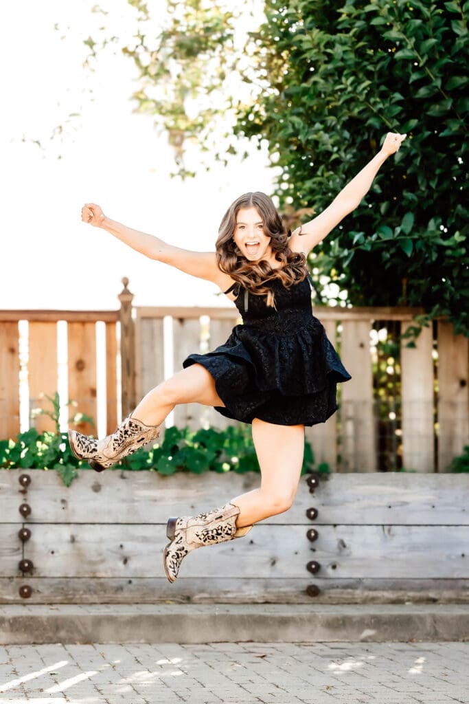 joyful image of a Senior girl jumping and clicking her heels