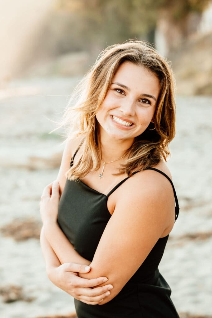 Up close backlit portrait of a senior girl on the beach