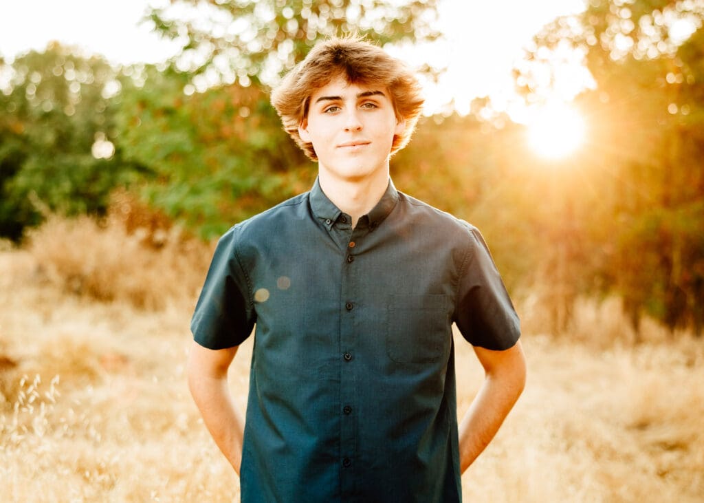 Backlit image of a senior boy for a blog post about what to wear for senior photos