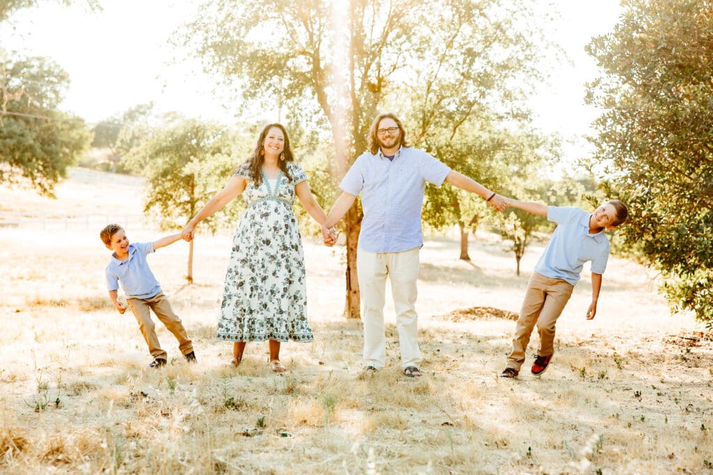 Family of 4 having fun during a family photo session with Sweet Whimsy Photography