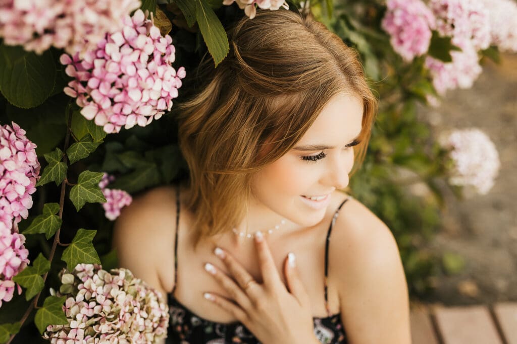 Senior girl surrounded by colorful flowers